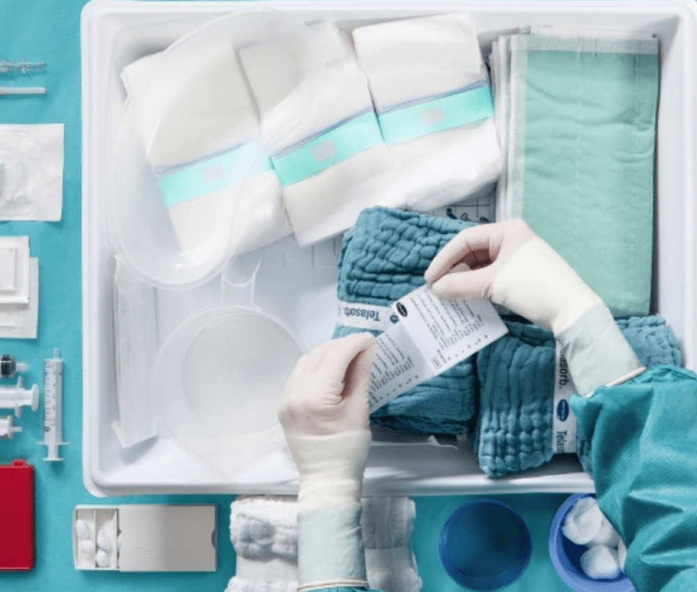 Medical staff preparing sterile equipment in an organized setup.